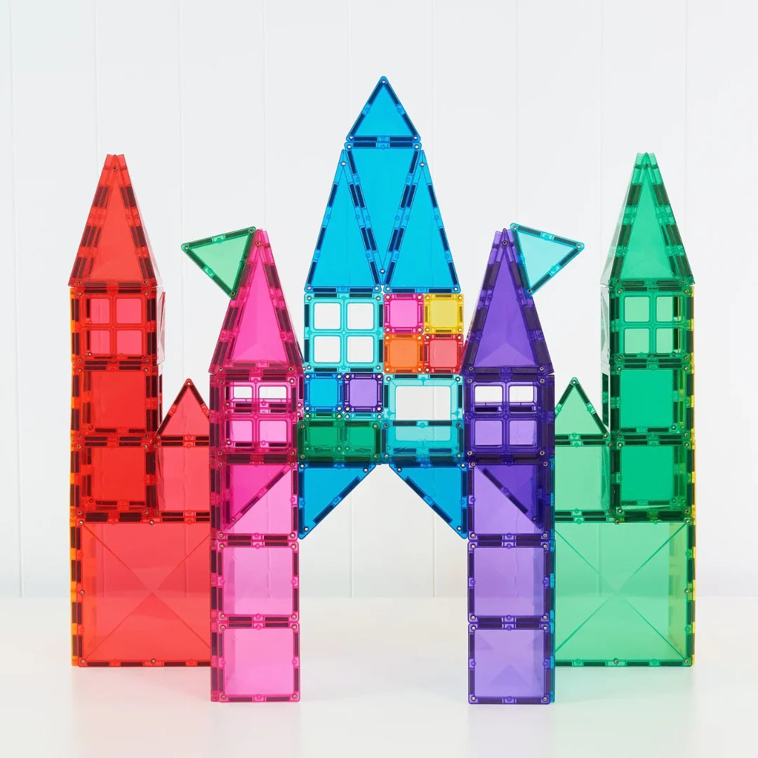 A set of translucent magnetic building blocks arranged to form a colorful castle structure.