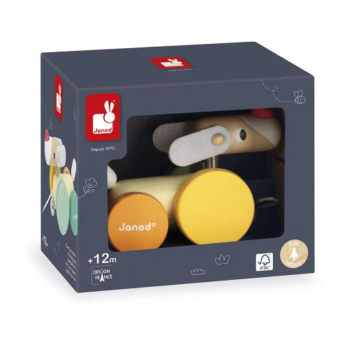 Toy packaging with a wooden toy inside, featuring Janod branding.