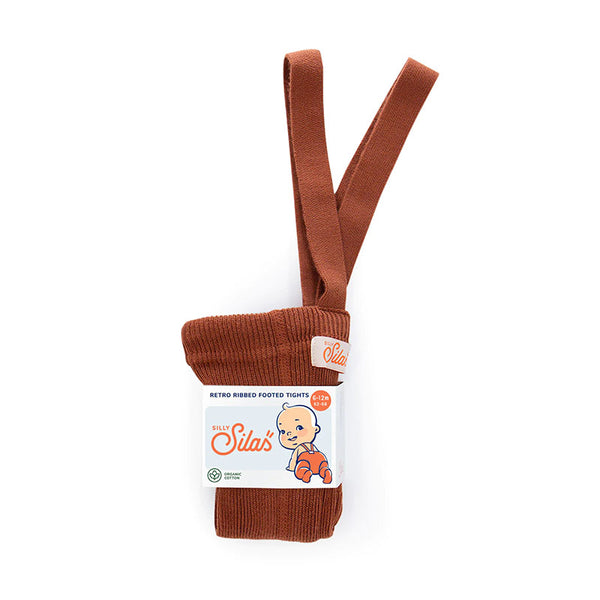 A pair of Silly Silas's retro ribbed footie tights in a warm rust brown color, packaged with a white paper label featuring the brand logo and a baby illustration