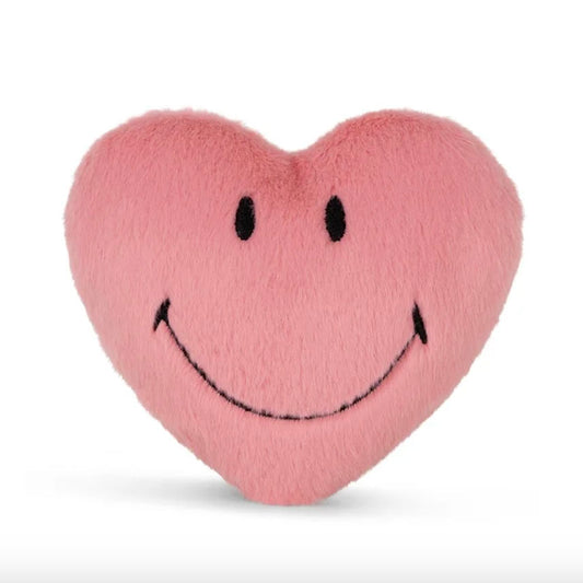 A pink plush heart-shaped plush toy with a simple black embroidered smiley face.