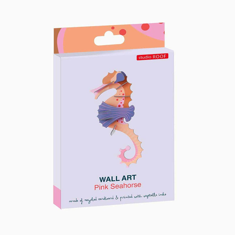 Studio Roof Pink Seahorse wall art in its original packaging, featuring a pastel purple box with a colorful seahorse illustration and a pink and orange hanging tab.
