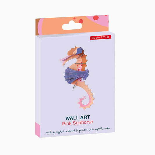Studio Roof Pink Seahorse wall art in its original packaging, featuring a pastel purple box with a colorful seahorse illustration and a pink and orange hanging tab.
