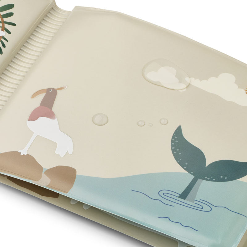 A close-up of a soft baby bath book with illustrated sea- and shore-themed graphics